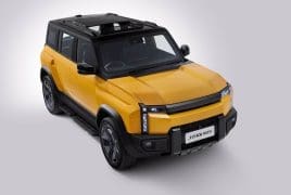 Three-quarter front-left view of a yellow SUV with a black roof and rugged bumper, set against a light gray background.