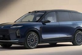 Blue ES8 electric SUV parked on a light surface, showing its sleek profile and multi-spoke alloy wheels.