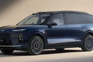 Blue ES8 electric SUV parked on a light surface, showing its sleek profile and multi-spoke alloy wheels.