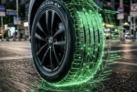Smart tire with a glowing green digital grid around the tread, illustrating intelligent vehicle tire technology on a city street.