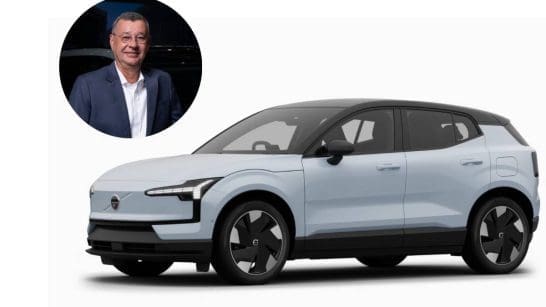 Light-blue electric SUV with a black roof shown in profile; circular inset photo of a smiling man in a suit at the top-left.