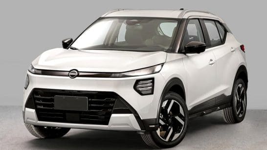 Three-quarter front view of a white crossover SUV with black trim, a wide black grille, and silver roof rails, shown indoors.